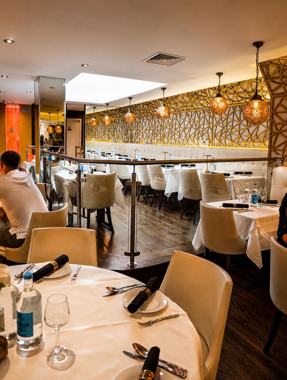 The elegant gold detailed dining room prepared for guests